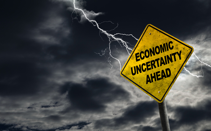 Lighting strikes sign labeled economic uncertainty ahead