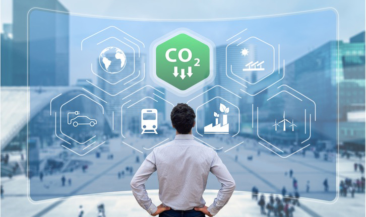 Office worker staring at a CO2 Icon trending downward
